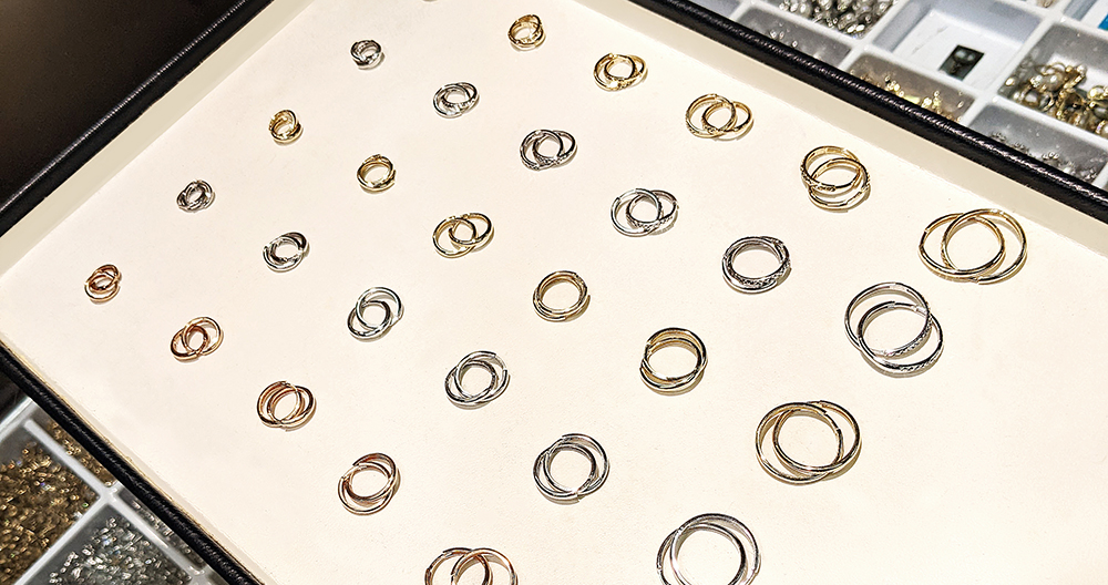 A tray of assorted gold hoop and huggie earrings seen from above, a complete gold earring assortment